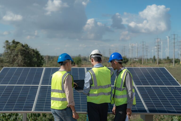 Team of engineers assessing a group of solar panels